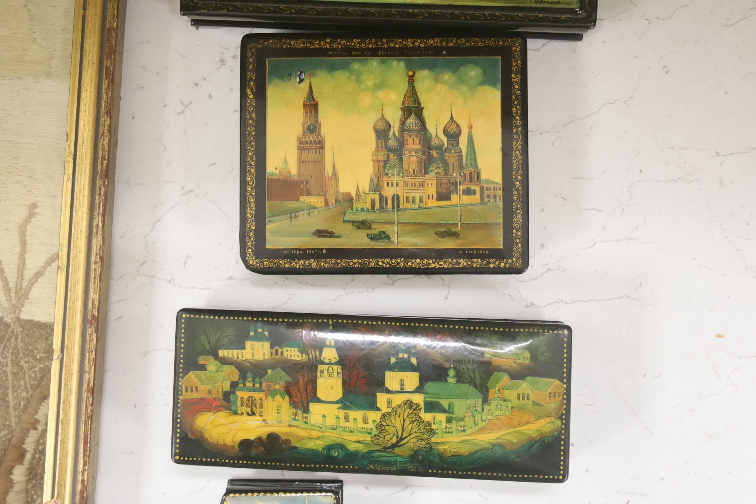 Six Russian Papier mache boxes, each decorated with churches or cathedrals, largest 17 cm